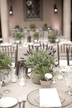 the table is set with flowers and wine glasses