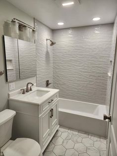 a bathroom with a toilet, sink and bathtub