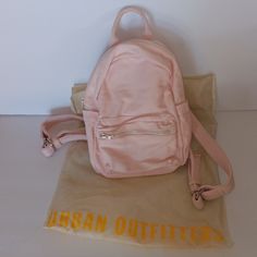 Urban Outfitters Mini Classic Canvas Backpack Blush Pink New 11"H X 9"L X 4"W Inch Interior Has 1 Slip Pocket Includes Urban Outfitters Shopping Bag Great For Gifts Hands-Free Bag Great For Casual, Travel, Vacation, Shopping Spacious Urban Outfitters Travel Bags For Summer, Urban Outfitters Summer Travel Bags, Pink Standard Backpack For Spring, Casual Pink Backpack For Spring, Pink Spring Backpack, Pink Summer Backpack With Zipper Closure, Pink Backpack For Everyday Spring Use, Pink Everyday Backpack For Spring, Summer Pink Backpack