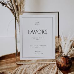 a sign that says cards and gifts next to a vase with dried grass in it