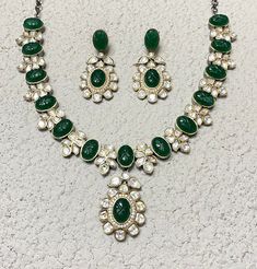 Polki Necklace Set features emerald green Kundan stones with a Sabyasachi-inspired design. Adorned with moissanite and Polki diamonds, it showcases intricate craftsmanship and elegant statement-making. Perfect for weddings, this piece blends traditional Indian artistry with contemporary sparkle, offering a stunning focal point for any bridal ensemble. *𝐏𝐑𝐎𝐃𝐔𝐂𝐓 𝐃𝐄𝐓𝐀𝐈𝐋* * Material: Brass * Plating: Gold Plated * Stone: Semi Precious Kundan & Polki. *𝐃𝐈𝐌𝐄𝐍𝐒𝐈𝐎𝐍𝐒* *  Necklace- Green Round Kundan Necklace With Gemstone, Luxury Green Kundan Danglers, Luxury Green Kundan Necklace With Stones, Green Diamond Kundan Necklace With Gemstone, Luxury Traditional Green Kundan Necklace, Green Kundan Necklace With Gemstone, Traditional Green Kundan Necklace, Luxury, Sabyasachi Jewelry, Sabyasachi Jewellery