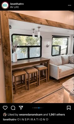 the interior of a mobile home with wood floors and white couches, windows, and table