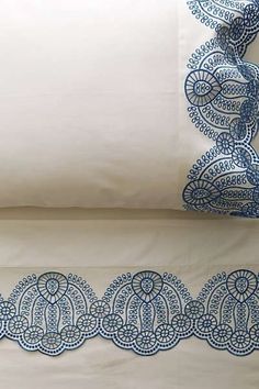 two pillow cases with blue designs on them