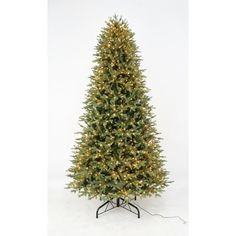 an artificial christmas tree with lights on it's base, in front of a white background