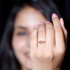 a close up of a person holding a ring