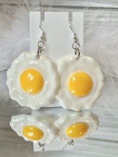 Introducing our adorable Egg earrings, Maximalist Style, Statement Earrings, Handmade Jewelry, Gift, Cloud Novelty, Gift Mode the perfect accessory for anyone who loves to make a statement with their fashion choices. These quirky and fun earrings capture the essence of these charming reptiles in a stylish and unique way. Crafted with attention to detail, they are sure to turn heads and spark conversations wherever you go. Product Details: Material: Plastic, Metal Size:  Approximately 2 inches length and approximately 1 3/4 inches width and 3 inches drop length Shape:  Misc Shipping:  We ship anywhere in the U.S.  See shipping policy for more information Returns:  We do not offer returns or swaps but please contact me if you have a problem with your order. Each of my items are all handmade. Handmade Novelty White Earrings, Novelty White Round Earrings, Fun White Jewelry With Matching Earrings, Handmade Novelty Earrings For Everyday, Fun White Earrings For Everyday, Fun White Everyday Earrings, Egg Earrings, Jewelry Clay, Weird Jewelry