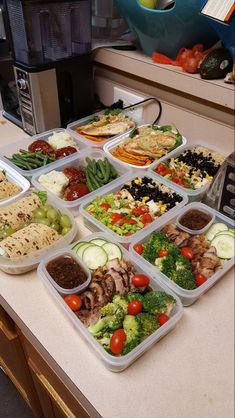 a bunch of trays filled with different types of food