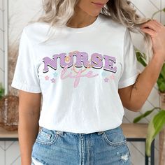 a woman with blonde hair wearing a white shirt that says nurse life