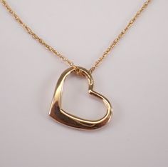 Small Heart Pendant and Chain crafted in 14 Karat yellow gold. The heart measures 10 X 12 mm and weighs .8 grams with the 18" included chain. The pendant and the chain are both 14K Yellow Gold and will be delivered promptly in a gift box. ADDITIONAL REQUESTS If you would like to see more pictures of this item, please let us know and we would be happy to provide them for you. Please contact us with all questions, we are here to help. Yellow Gold Heart Necklace, Small Heart Pendant, Gold Heart Necklace, Necklace Dainty, Small Heart, Fine Jewelry Gift, Gold Heart, Heart Of Gold, Heart Necklace