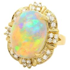 12.70 Carats Natural Impressive Ethiopian Opal and Diamond 14K Solid Yellow Gold Ring Total Natural Opal Weight is: Approx. 12.00 Carats Opal Measures: 18.00x 13.00mm Total Natural Round Diamonds Weight: Approx. 0.70 Carats (color G-H / Clarity SI1-SI2) Ring size: 6.5 (we offer free re-sizing upon request) Ring total weight: Approx. 10.0 grams Disclaimer: all weights, measurements and colors are approximate and may vary slightly from the listed dimensions or as seen in the image. All pictures ar Expensive Rings, Opal Band, Emerald Cut Rings, Etsy Gold Ring, Yellow Gold Ring, Dream Jewelry, Natural Opal, Sapphire Diamond, Quality Diamonds