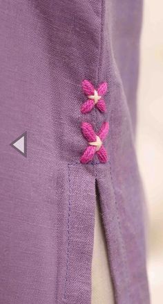 a purple jacket with pink flowers on the lapel