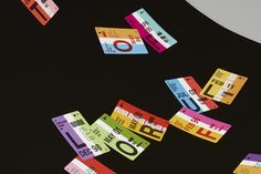 colorful tickets are flying through the air on a black background with white and red stripes