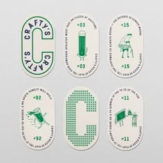 four green and white stickers with the letter c on them