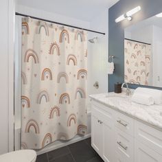 a bathroom with a shower curtain, toilet and sink in the background is a blue wall