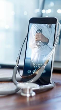 a cell phone with a stethoscope attached to it sitting on a table