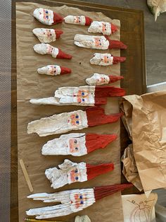 paper mache heads are displayed on a piece of brown paper with red, white and blue designs