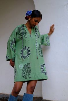 This mini dress is brought to life with our eclectic JODI hand block printed motifs. Crafted in cotton, it has a relaxed shape and a hood detail with checks. Look closely and you will see a cutesy bead hand embroidery detail too. We believe you have a right to know how this product was made. 3 meters of south Indian mangalgiri cotton fabric sourced from Jaipur has been used for this piece. Hand printed by our artisans in Jaipur, manufactured in our workshop at Pune, India. If you wish to have th Hand Printed Cotton Dresses, Fitted Festival Dress With Block Print, South Indian Fashion, Traditional Multicolor Block Print Kaftan, Indian Print Dress, Wrap Waist Dress, Festive Multicolor Block Print Kaftan, Cotton Block Print Semi-stitched Dresses, Jaipur Dresses Block Prints