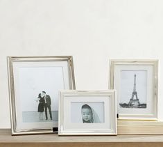 three framed photographs sitting on top of a wooden shelf next to two frames with the same photo