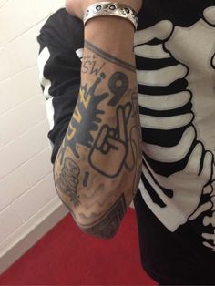 a man with tattoos on his arm and wrist