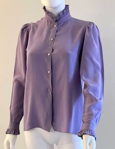 "Vintage C1980s elegant, Victorian style, pure silk blouse in a gorgeous shade of lavender by Gloria Sachs, featuring a fully pleated collar and cuffs.  Front button closure. Approximate Measurements:      Bust: 36\"; Waist: 36\"; Length: 23\"      Labeled a size 6 Pure quality and style, this C1980s Gloria Sachs blouse is in very good vintage condition, as shown; with some imperfections (see example in next to last photo)." Chic Lavender Blouse For Fall, Chic Lavender Blouse For Work, Elegant Lavender Blouse For Spring, Purple Blouse For Spring Formal Occasion, Chic Lavender Blouse For Workwear, Elegant Mauve Tops For Spring, Elegant Purple Blouse For Spring, Elegant Purple Spring Blouse, Elegant Long Sleeve Lavender Tops