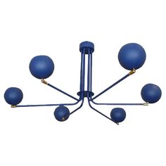 a blue chandelier with six balls hanging from it's arms and four lights on each end