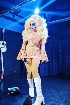 lady in pink dress and white boots on stage