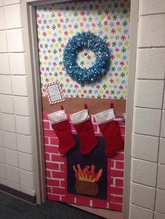 a door decorated with stockings and christmas stockings hanging from the side of a brick wall