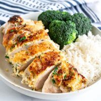 a white plate topped with chicken, rice and broccoli