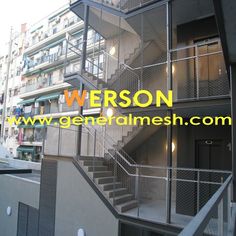 an apartment building with stairs and balconies on the second floor that lead up to the third floor