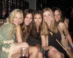 a group of young women sitting next to each other