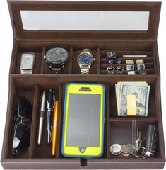 an open briefcase filled with lots of items including a cell phone, watch and pen