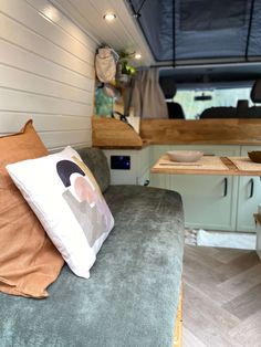 the interior of a camper with a couch and table