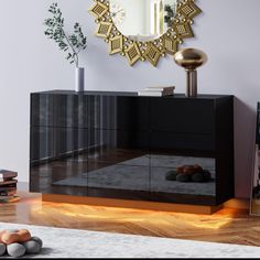 a black and gold sideboard in a living room with a mirror on the wall