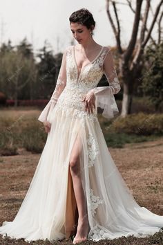 Vintage-inspired and romantic, this boho wedding dress features an eye-catching illusion bodice with bell sleeves, delicate deep V-neckline adorned with dot lace trim, a flattering back with button closure, and fine floral lace cascading down to fit and flare skirt with high slit. #weddingdress #bridaldress #designerweddingdress #springweddingdress #fallweddingdress #winterweddingdress #summerweddingdress #bohoweddingdress #beachweddingdress #destinationweddingdress Wedding Gown Bell Sleeves, Nude Wedding Dress, Beige Wedding Dress, Puff Sleeve Wedding Dress, Nude Wedding, Party Dress Inspiration, Beige Wedding, Spring Wedding Dress, Designer Bridesmaid Dresses