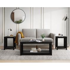 a living room scene with focus on the couch and coffee table, along with a round mirror