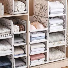 an organized closet filled with folded and folded towels, blankets, and other linens