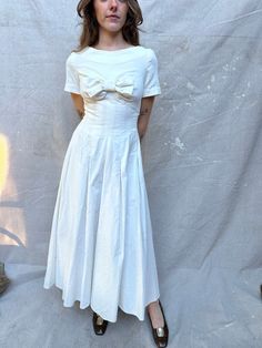 "Incredible 1950s Handmade White Velvet Dress / Big Bow at Bust / Center Back Zipper / Unlined which leaves room for letting out the waist seams if needed / Very Special One of a Kind / Perfect for Bridal / Full Sweep ! Measurements: Size XS - can be let out by tailor LAID FLAT Waist: 25\" Chest: 32\" Front Length from HPS: 48\" Shoulder: 13 1/2\" Sleeve Length: 7 1/8\" Sweep: 164\"  100% Velvet Condition:  Great vintage condition.  ** ALL SALES ARE FINAL , ask for detailed photos if needed **" Vintage Formal Dress With Box Pleat, 1950s Style A-line Vintage Dress For Daywear, Vintage Dresses With Bow And Short Sleeves, 1950s Style Formal Tea Length Vintage Dress, Vintage Short Sleeve Dress With Bow, Vintage Dress With Box Pleat For Vintage Fashion, Cream 1950s Style Vintage Dress, 1950s A-line Vintage Dress, 1950s Style Cream Vintage Dress