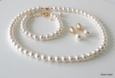 "This timeless pearl set has cubic zirconia earrings, Austrian pearls necklace and bracelet in white. Please make your own set or purchase separately at checkout. Necklace measures approximately 17\" long with 2\" extender chain for additional length. Bracelet is about 7 1/4\" long with 1 1/2\" extender chain. Earrings have cubic zirconia studs with sterling silver posts and 10 mm Austrian pearls and measure just over 1\" long from top to bottom. Perfect for a classy bride or any special occasio Classic White Jewelry Sets For Wedding, Elegant White Jewelry Sets For Bridesmaids, Elegant Pearl Jewelry Sets With Round Beads, Elegant White Pearl Necklace For Bridesmaids, Pearl Drop Round Beads Jewelry Set For Wedding, Pearl Drop Wedding Jewelry Sets With Round Beads, Simple Pearl Earrings, Bridal Bracelet Pearl, Simple Pearl