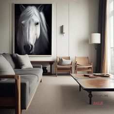 a living room filled with furniture and a large painting on the wall above it's coffee table