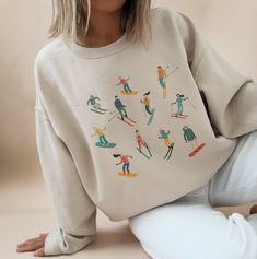 ✺  SKI SWEATSHIRT CREWNECK ✺  It's an amazing super comfy and soft sweatshirt, perfect for cold autumn days, and what makes it even better, it looks amazing on photos ! I am obsessed with this design and you will be as well <3 * Q U I C K F A C T S * This design is a unique illustration that has been created in house. ✺ 50% Cotton 50% Polyester ✺ Medium-heavy fabric (8.0 oz/yd² (271.25 g/m ✺ Sizing is unisex so runs like men's, though not overly large ✺ Most women find their typical size works best, since they are meant to fit a touch loose Please note that COLOURS MAY APPEAR DIFFERENT on different digital screens and may not be a true representation of the actual colours. * K E E P S H O P P I N G *   * Shop our entire Bachelorette collection here: https://www.etsy.com/au/shop/thingsyoure Winter Sweatshirt Designs, State Sweatshirts, Ski Sweatshirt, Sweatshirt Graphic Design, Snowflake Sweatshirt, Winter Apparel, Graphic Design Sweater, Crew Neck Sweatshirt Design, Ski Shirt