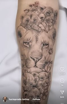 a black and white tattoo on the leg of a woman with lions around her head