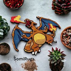 some plants and potted plants are sitting on the table with embroidered patches that say, somiruss