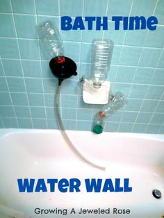 there is a bath time water wall in the bathroom with two bottles attached to it