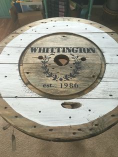 a wooden table with a sign that says wittington established in the bottom right corner