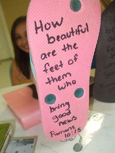 a pink shoe with writing on it sitting next to a woman's face and the words how beautiful are the feet of them