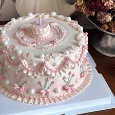 a decorated cake sitting on top of a table