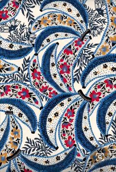 blue and red paisley print fabric with white, black, pink, orange and yellow flowers