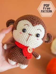 a small crocheted monkey with a red scarf on it's neck and eyes