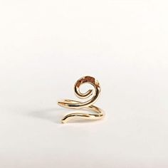 a gold spiral ring on a white background