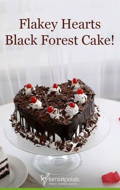 a heart shaped black forest cake sitting on top of a table